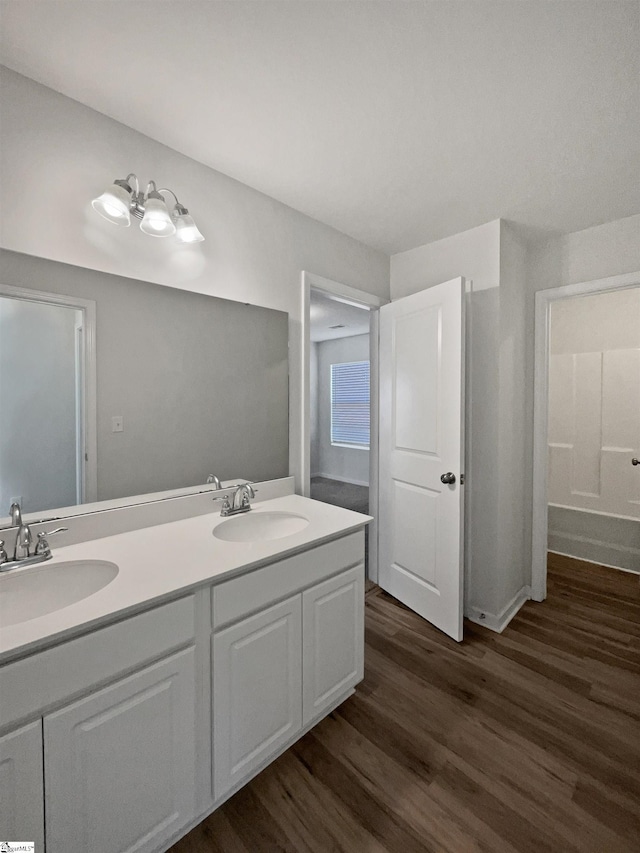 bathroom with hardwood / wood-style flooring and vanity