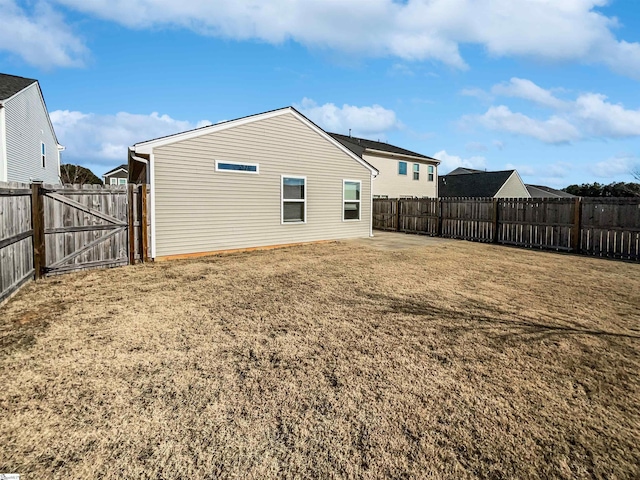 rear view of property featuring a yard