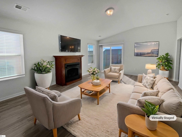 living room with vaulted ceiling and wood-type flooring