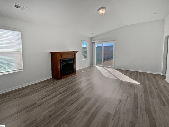 unfurnished living room with dark hardwood / wood-style floors and lofted ceiling