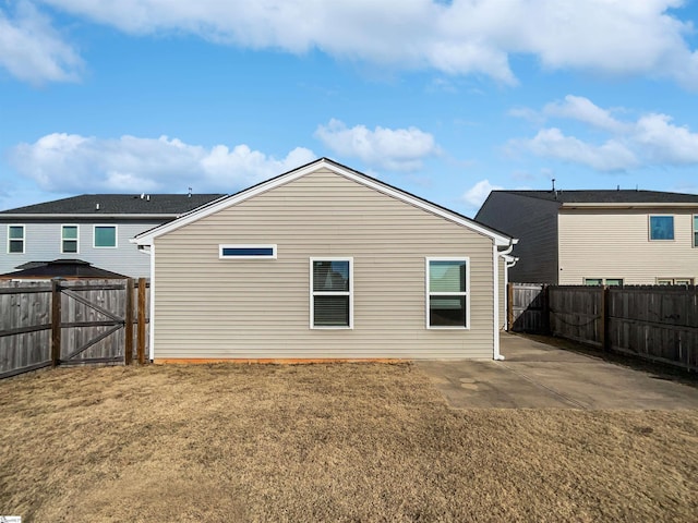 rear view of house with a yard and a patio