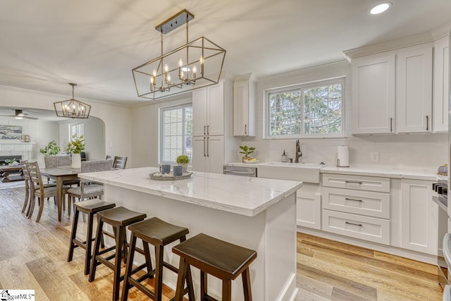 kitchen with white cabinetry, a center island, and decorative light fixtures