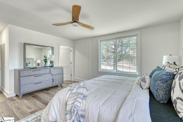 bedroom with ceiling fan and light hardwood / wood-style floors