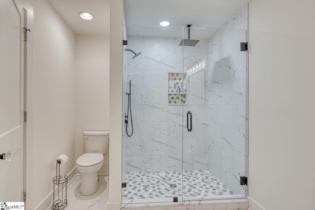 bathroom featuring an enclosed shower and toilet