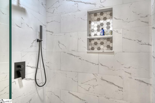 bathroom with tiled shower