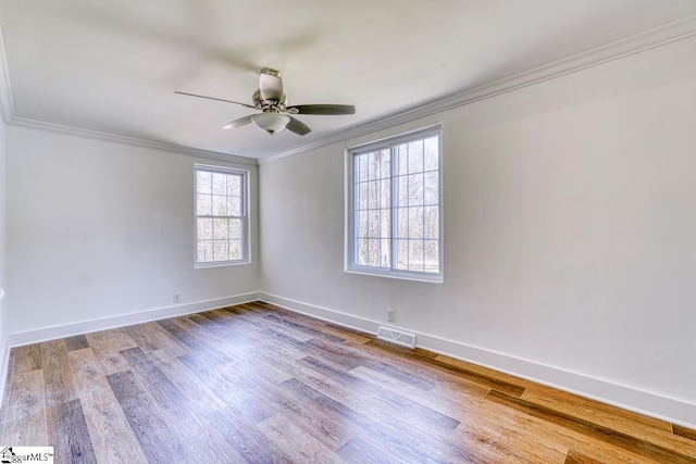 empty room featuring ceiling fan, ornamental molding, and hardwood / wood-style floors