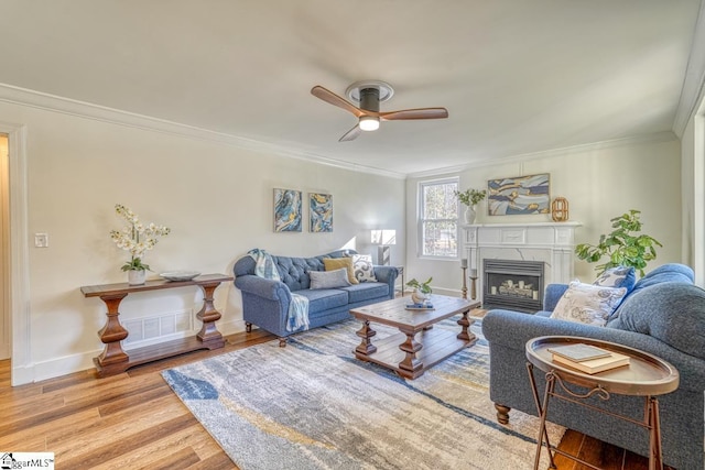 living room featuring ceiling fan, crown molding, and hardwood / wood-style flooring