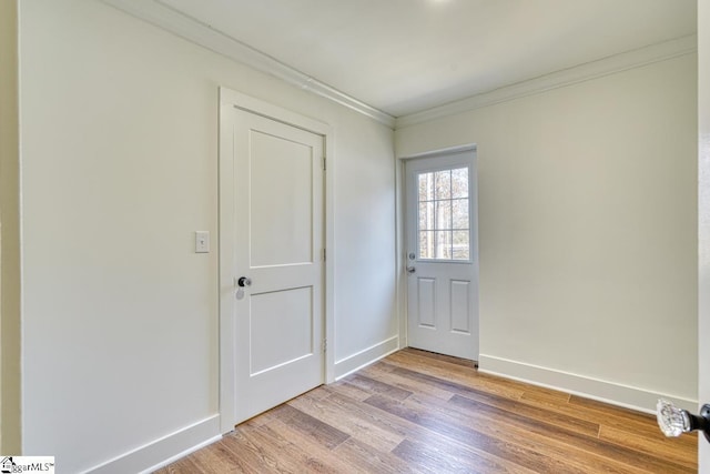 spare room with ornamental molding and hardwood / wood-style floors