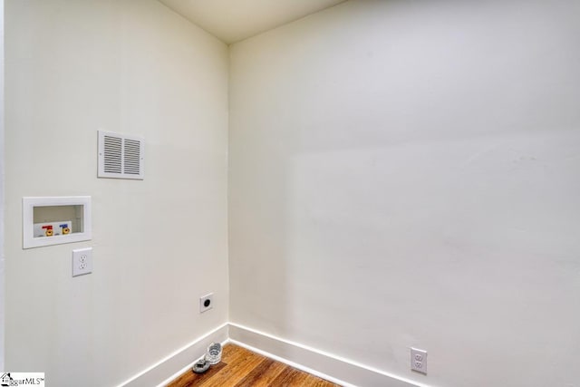 laundry room featuring hookup for a washing machine, electric dryer hookup, and hardwood / wood-style flooring