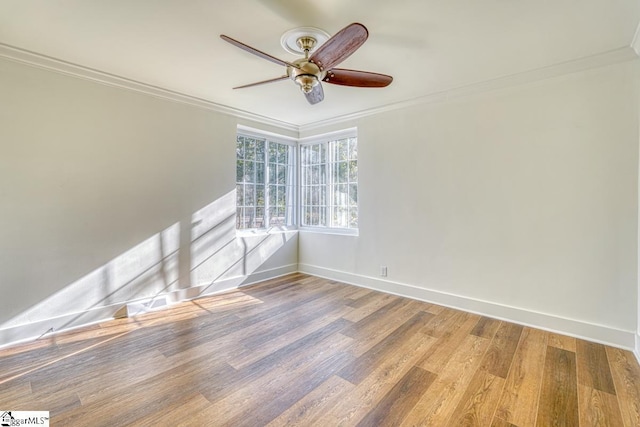 spare room with ceiling fan, ornamental molding, and wood-type flooring