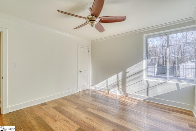 spare room featuring ceiling fan, crown molding, and light hardwood / wood-style floors