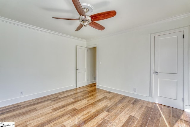 unfurnished room with ceiling fan, light hardwood / wood-style floors, and crown molding