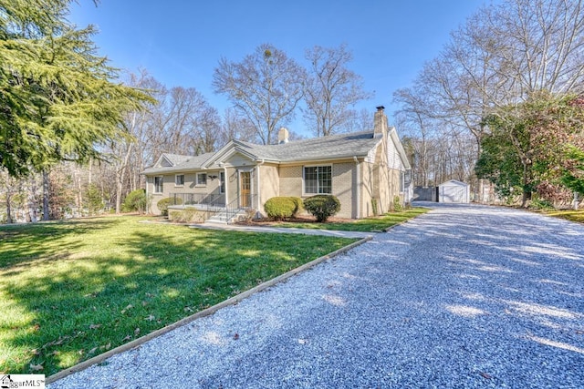 view of front of house with a front lawn and an outdoor structure