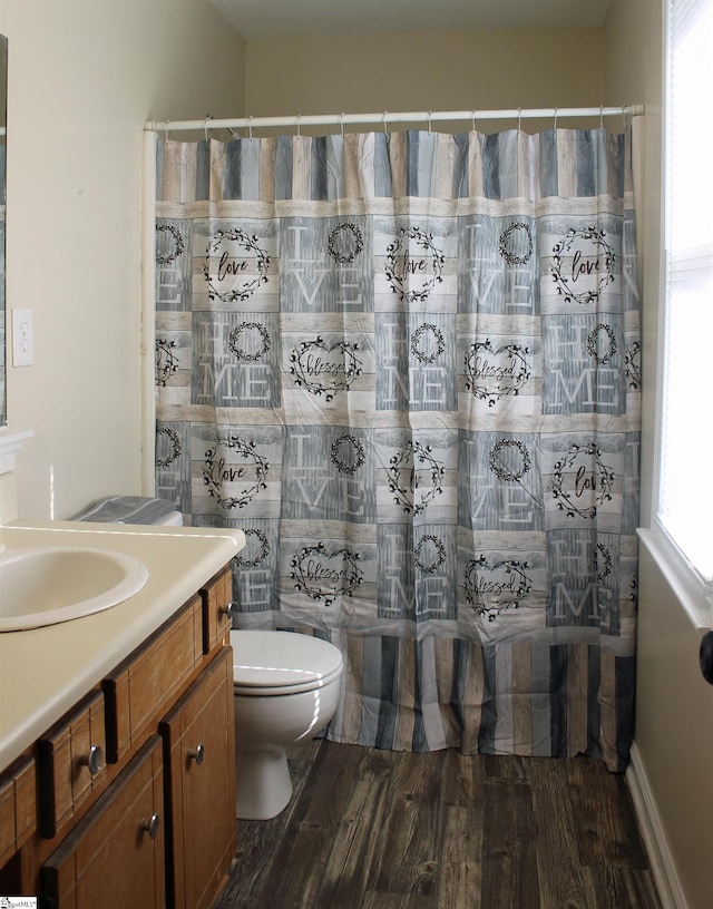 bathroom with curtained shower, wood-type flooring, toilet, and vanity