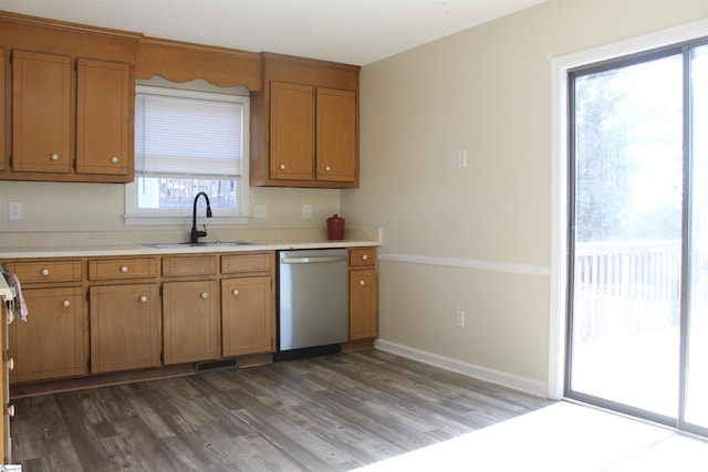 kitchen featuring dark wood-type flooring, sink, and dishwasher