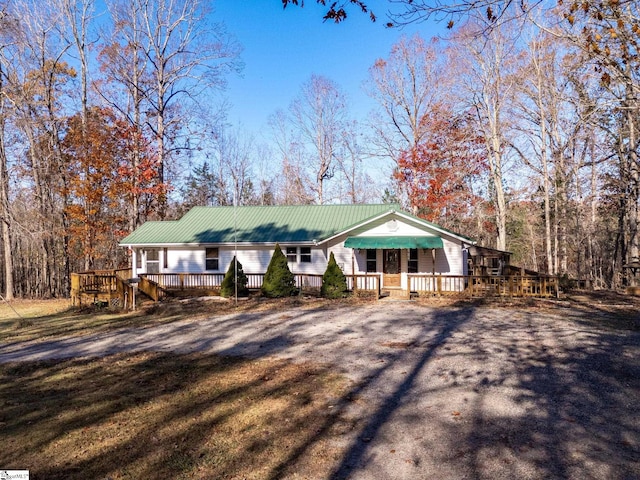 single story home with covered porch and a deck