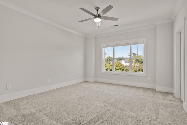 carpeted spare room with ceiling fan and crown molding