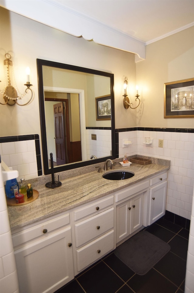 bathroom with ornamental molding, tile patterned floors, tile walls, and vanity