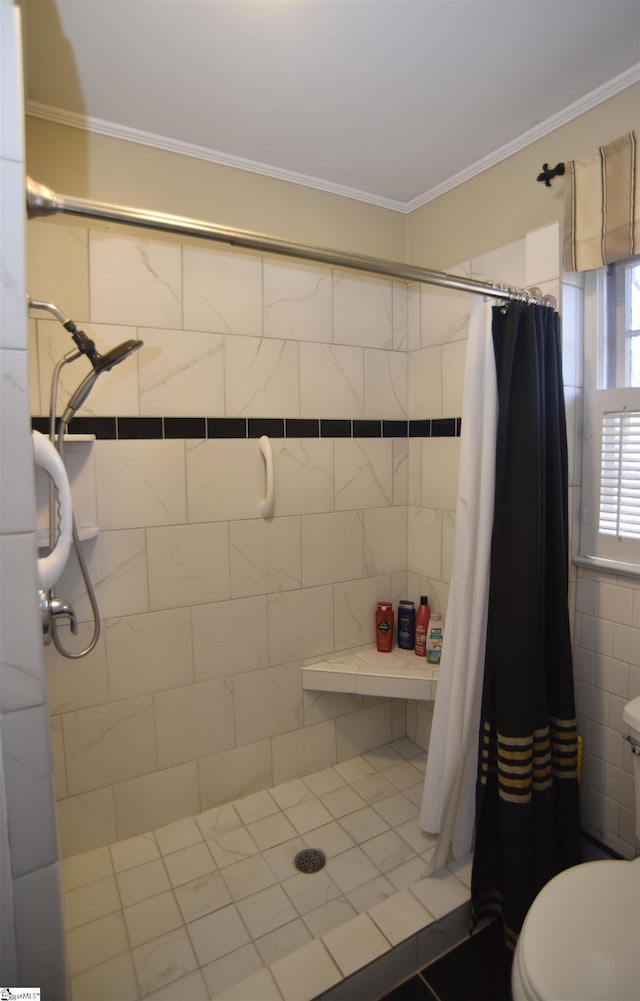 bathroom with ornamental molding, toilet, and walk in shower