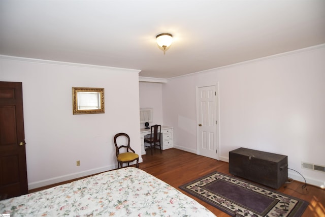 bedroom with crown molding and dark hardwood / wood-style flooring