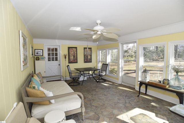 sunroom featuring ceiling fan