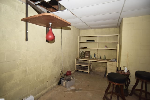 basement featuring a paneled ceiling