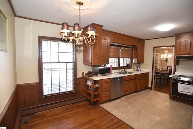 kitchen featuring a baseboard radiator, plenty of natural light, a notable chandelier, pendant lighting, and stainless steel appliances