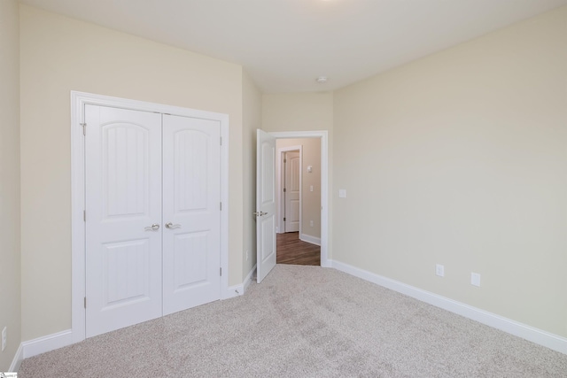 unfurnished bedroom with a closet and carpet flooring