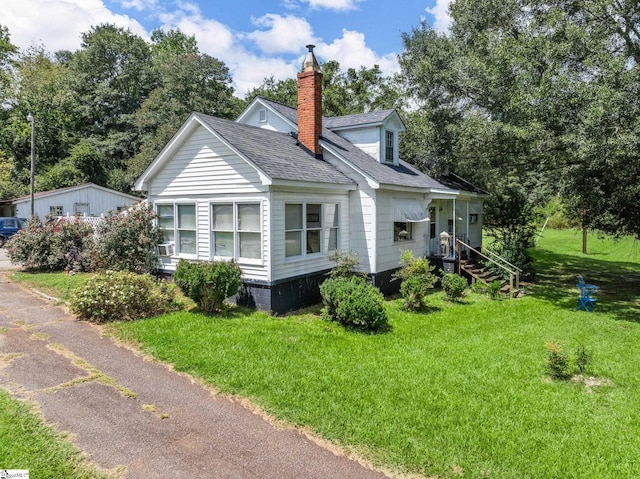 view of side of home with a lawn