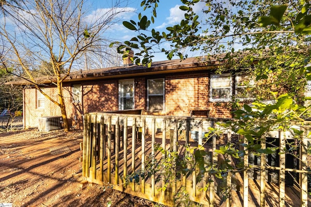 view of property exterior featuring a deck and cooling unit