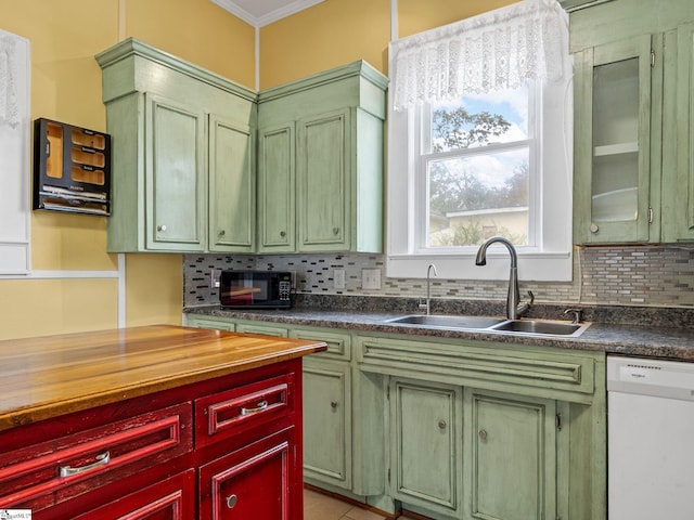 kitchen featuring decorative backsplash, sink, ornamental molding, white dishwasher, and light tile patterned floors