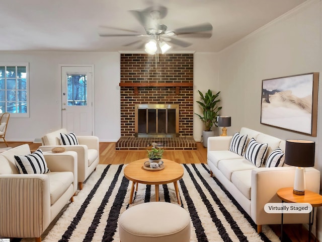 living room with a brick fireplace, light hardwood / wood-style flooring, and ceiling fan