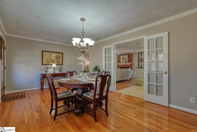 dining room with ornamental molding and a textured ceiling