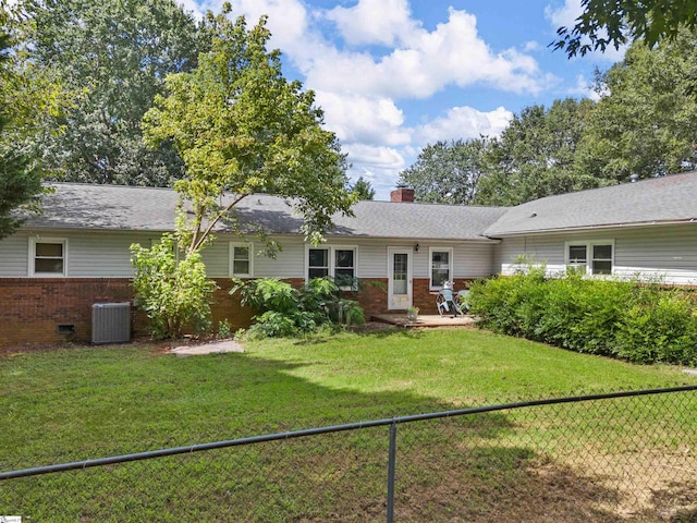 back of house with a yard and central AC unit