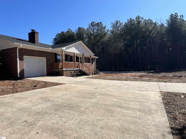 view of front of house featuring a garage and a porch