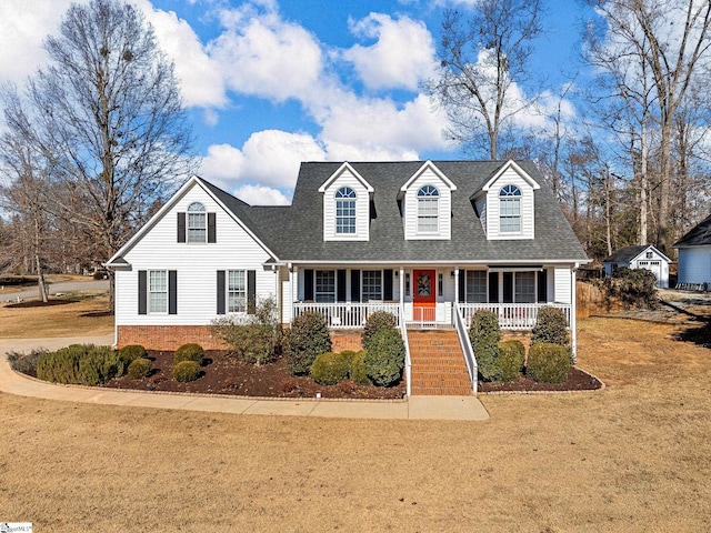 cape cod-style house featuring a front lawn and a porch