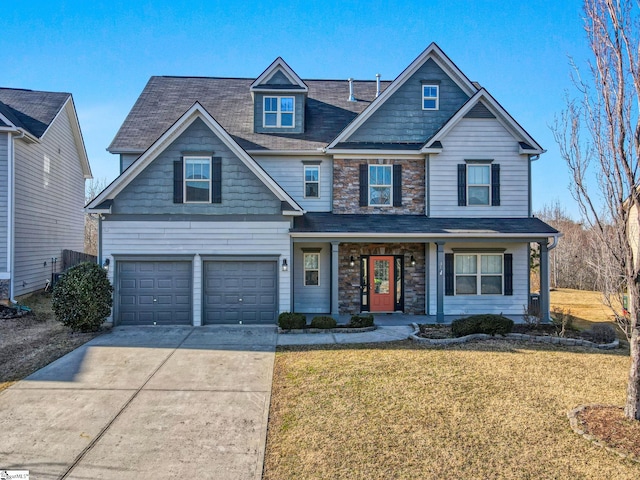 craftsman-style home featuring a front lawn, a porch, and a garage