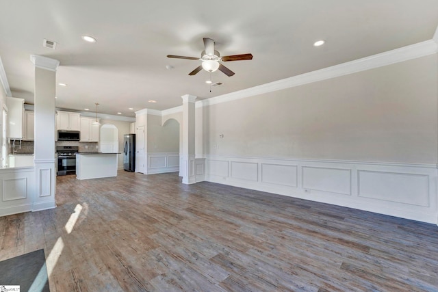 unfurnished living room featuring crown molding, ceiling fan, and dark hardwood / wood-style floors