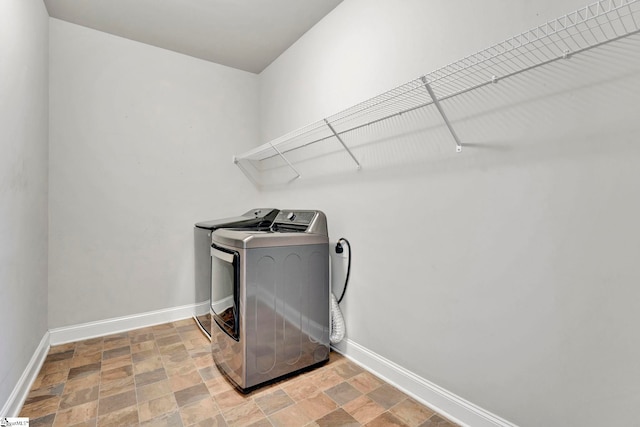 clothes washing area with separate washer and dryer