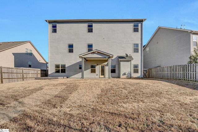 back of property featuring a lawn