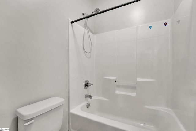 bathroom featuring shower / washtub combination and toilet