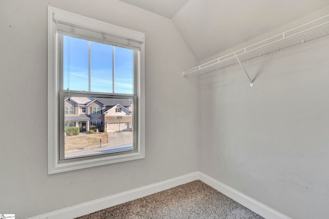 walk in closet featuring vaulted ceiling