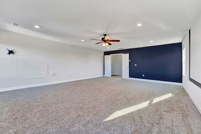 spare room with carpet and ceiling fan