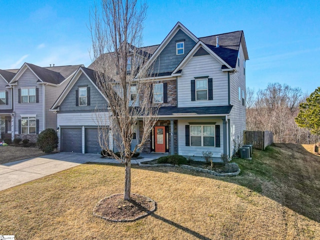 view of front of home featuring central AC, a garage, and a front lawn