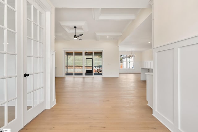 hall with beamed ceiling, light hardwood / wood-style floors, coffered ceiling, and a notable chandelier