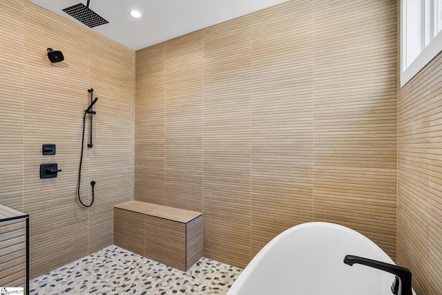 bathroom featuring shower with separate bathtub