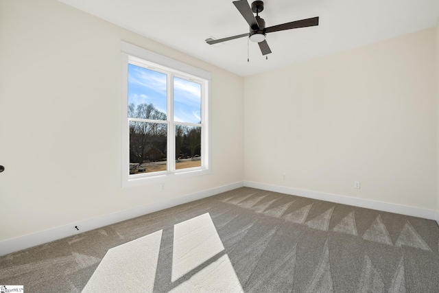 spare room featuring carpet and ceiling fan