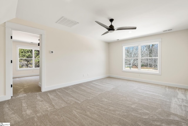 spare room featuring ceiling fan, lofted ceiling, and light carpet