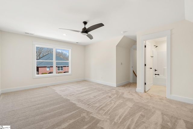 interior space featuring light carpet, ceiling fan, and vaulted ceiling