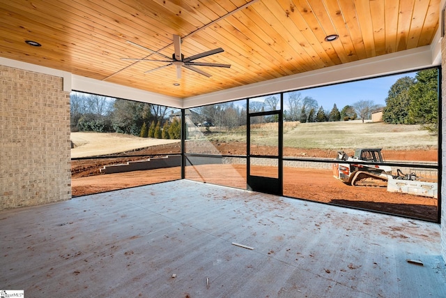 unfurnished sunroom featuring ceiling fan and wood ceiling